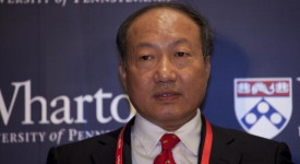 Chen Feng, chairman of Hainan Airlines, speaks at the Wharto